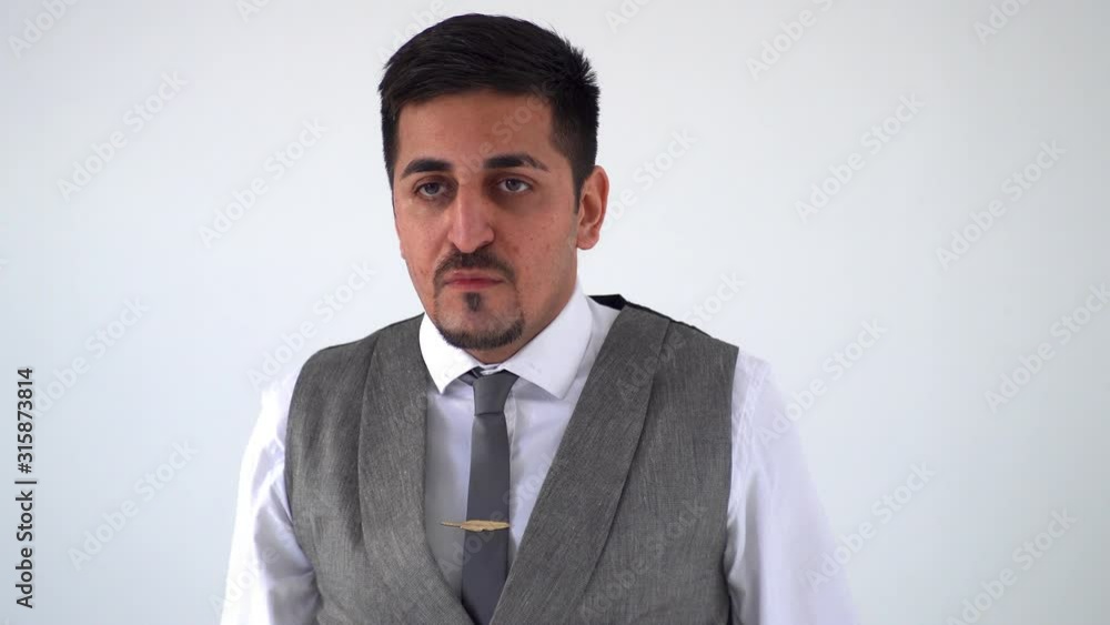 An Arab in an expensive suit waves his head and crosses his arms, a sign of refusal An Arab in an expensive suit waves his head and crosses his arms, a sign of refusal