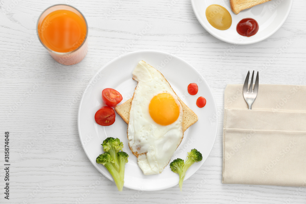 Tasty fried eggs with vegetables and juice on white wooden table, flat lay. Delicious morning meal Tasty fried eggs with vegetables and juice on white wooden table, flat lay. Delicious morning meal