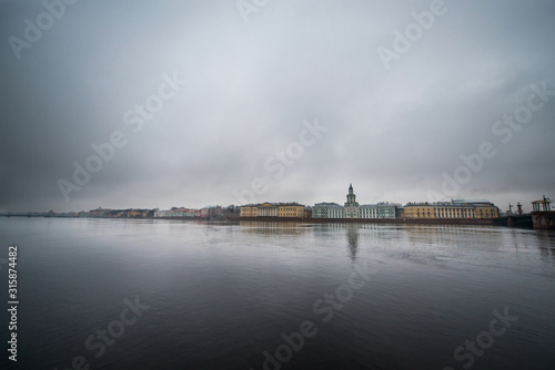 Saint Petersburg, low, grey winter sky, the view of the embankment of the Neva river and beautiful old buildings