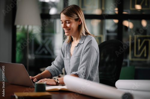 Young businesswoman working on project. Beautiful architect in office. 