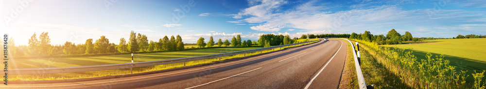 Obraz premium asphalt road panorama in countryside on sunny summer day