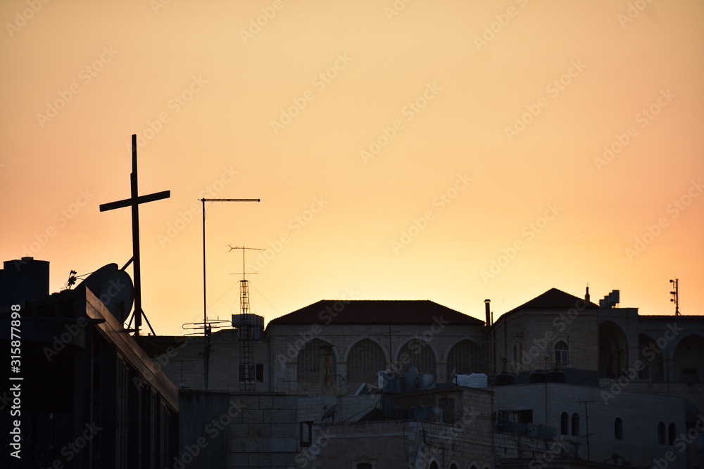Orange sunset with a cross in Bethlehem
