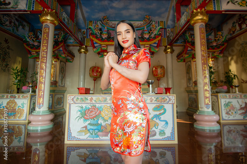 happy Chinese new year. Asian girl with gesture of congratulation © kowit1982