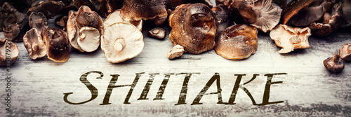 Shiitake mushrooms on wooden table, Lentinula edodes header photo