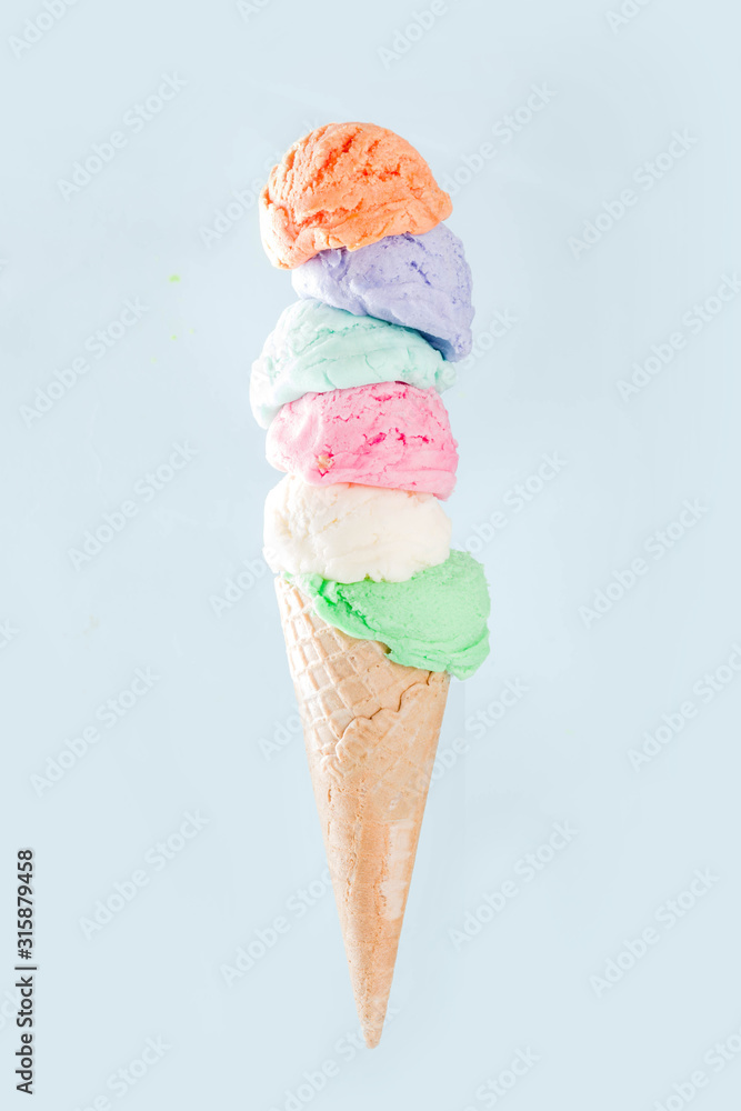 Stack of pastel colorful ice cream scoops in waffle cone, isolated on ...