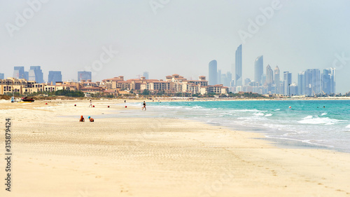 Saadiyat sandy beach with Abu Dhabi skyline at horizon photo