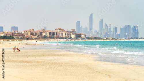 Saadiyat sandy beach with Abu Dhabi skyline at horizon