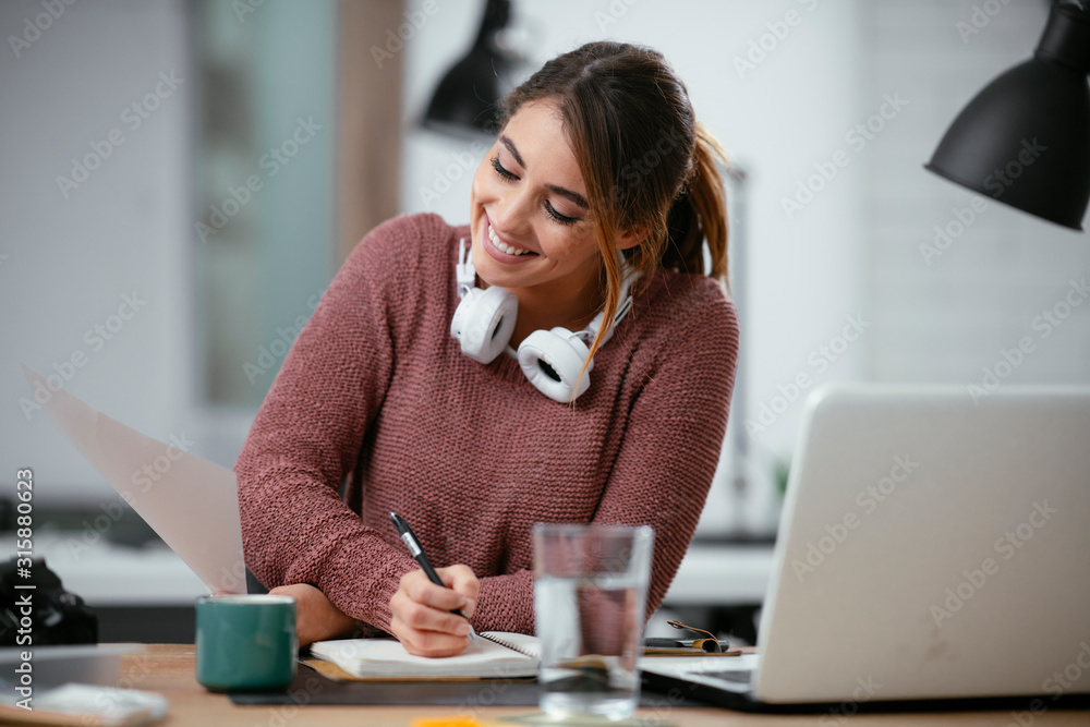 Businesswoman in office. Beautiful young woman working on paperwork at her workplace. Businesswoman in office. Beautiful young woman working on paperwork at her workplace.