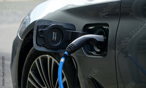 Electric or hybrid car refueling electricity at a charging station 