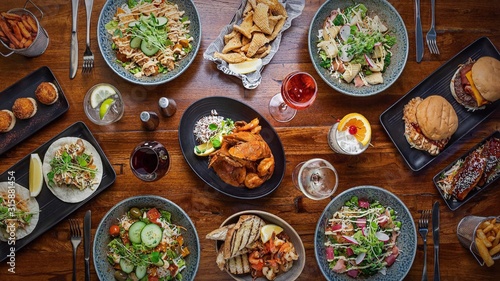 Plates of food and drinks on a wooden table