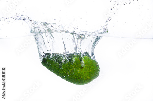 avocado drops in water on a white background