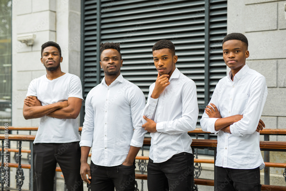 four handsome young african men in white shirts four handsome young african men in white shirts