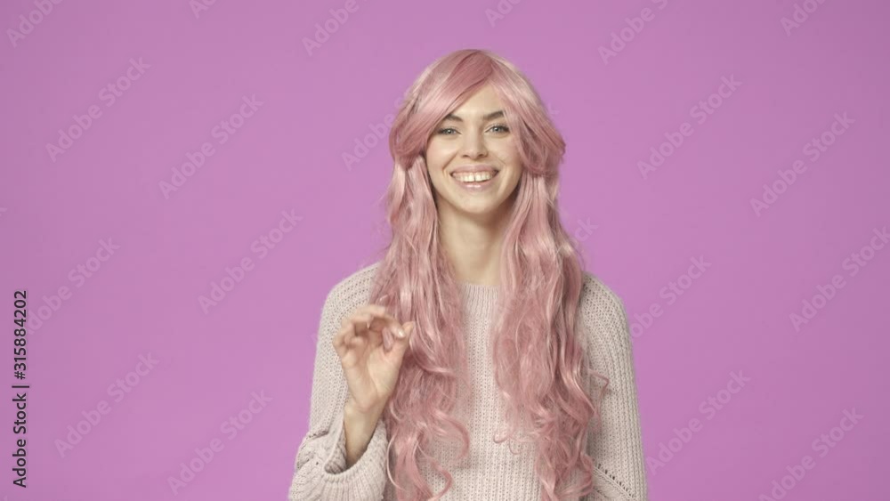 It was good. Slow-motion cute, adorable european woman in pink wig, agree with friend, showing alright, okay gesture, assure all ok, everything fine, agree or approve something, purple background It was good. Slow-motion cute, adorable european woman in pink wig, agree with friend, showing alright, okay gesture, assure all ok, everything fine, agree or approve something, purple background