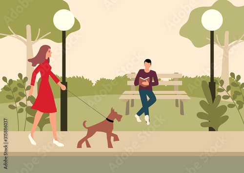 Woman and terrier dog walking in the park