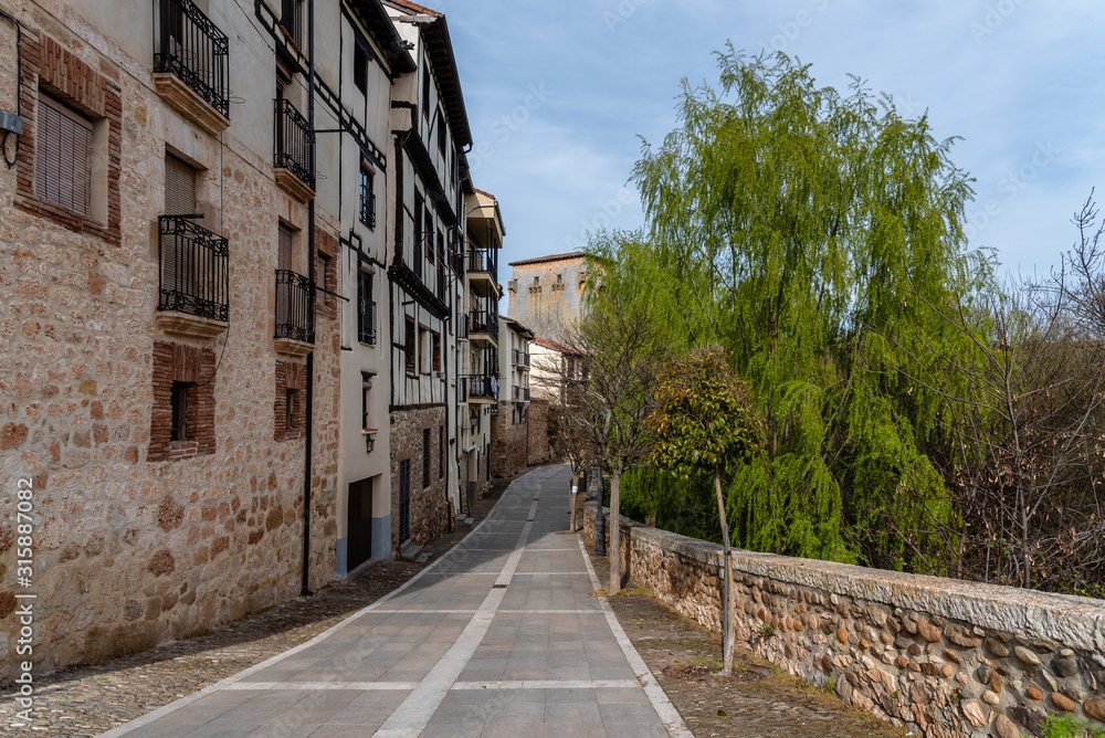 Picturesque view of the promenade along the river Arlanza in the village of Covarrubias