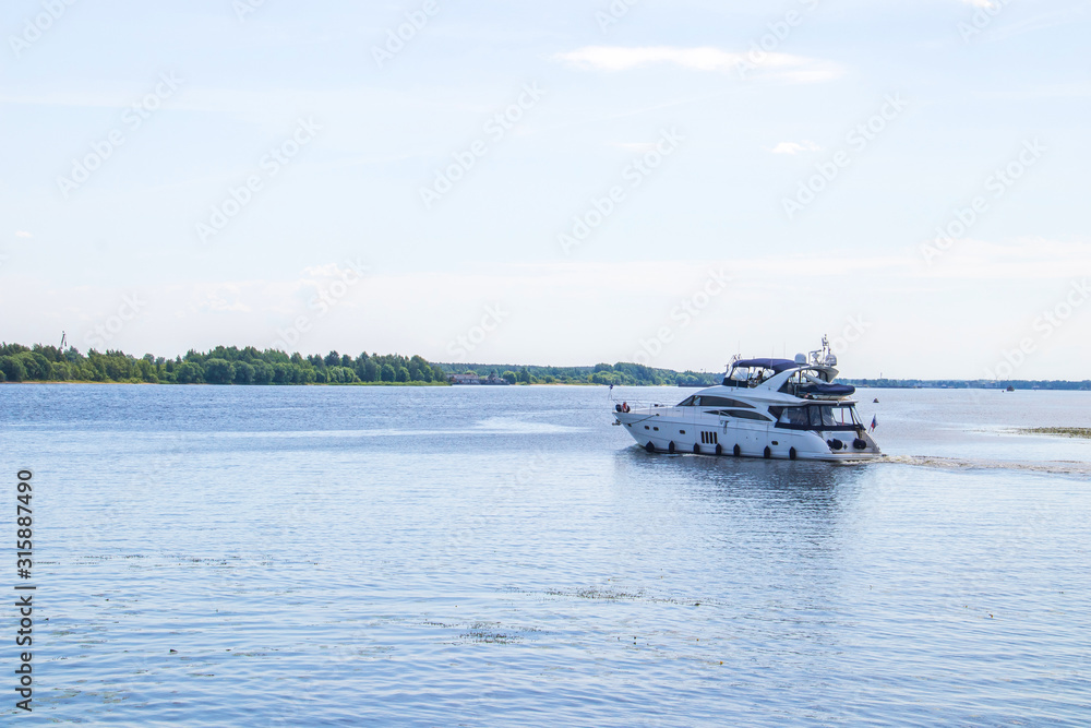Obraz premium The Golden ring of Russia. Sunny summer day in Yaroslavl. Bank of the Kotorosl river. Boats on the river
