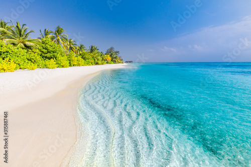 Summer travel destination. Design of summer vacation holiday concept. Perfect tranquil beach scene, soft sunlight and white sand and blue endless sea as tropical landscape © icemanphotos