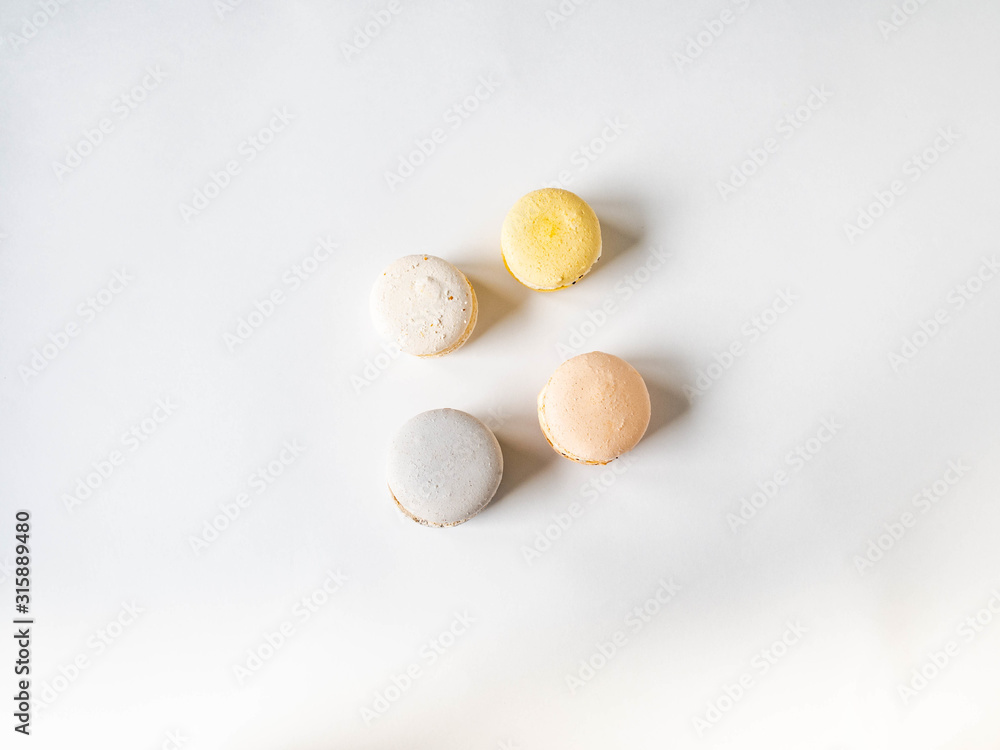 Four fresh french pastel colorful macarons on white background. top view Four fresh french pastel colorful macarons on white background. top view