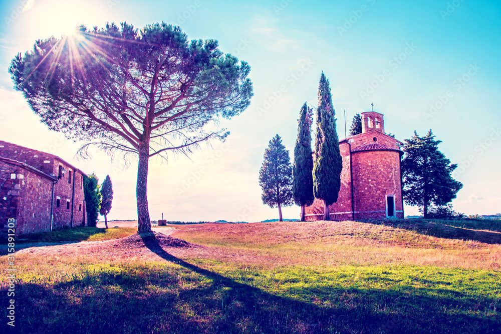 Magic landscape with chapel of Madonna di Vitaleta on a sunny day in San Quirico d'Orcia (Val d'Orcia) in Tuscany, Italy. Excellent tourist places.