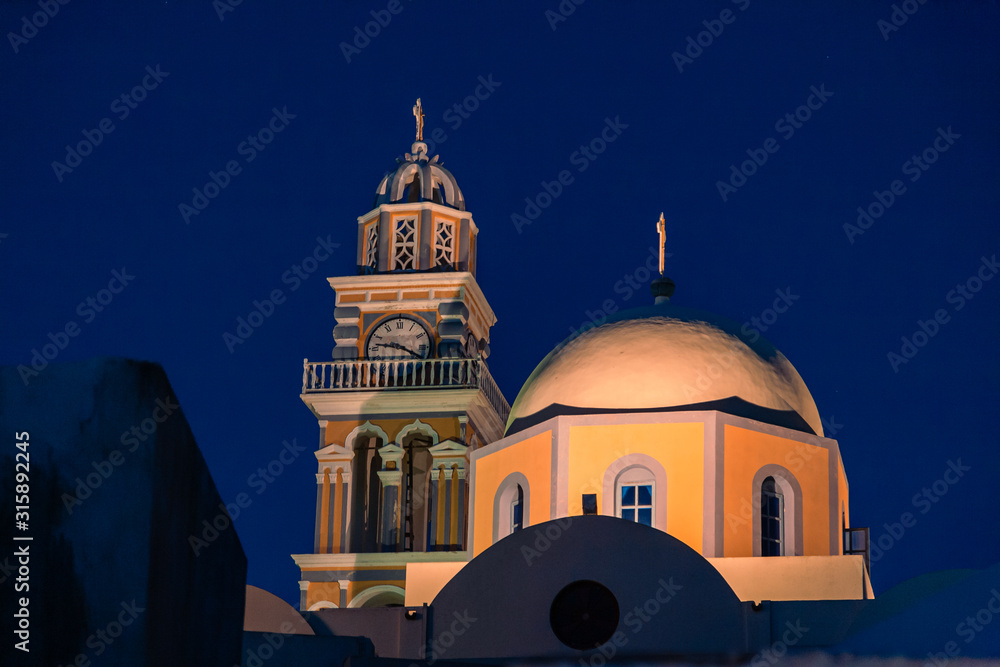 Casual view on the Fira capital of Santorini at summer evening low light photo
