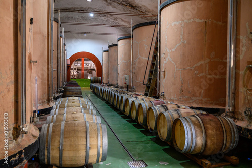 Traditional winery bodega on south of La Palma island with steel or concrete casks and wooden barrels in wine cellars, wine production on Canary Islands, Spain photo