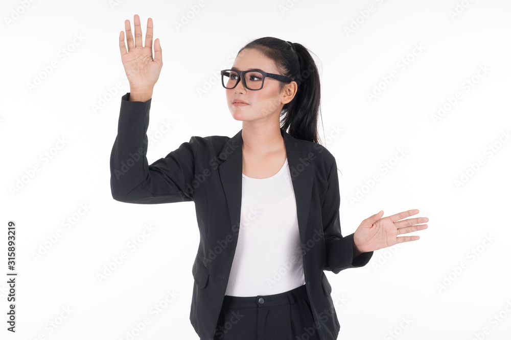 An attractive woman wearing business attire waving her hands in the air navigating on an invisible screen isolated on white. Suitable for image cut out and manipulation works for technology, business. An attractive woman wearing business attire waving her hands in the air navigating on an invisible screen isolated on white. Suitable for image cut out and manipulation works for technology, business.