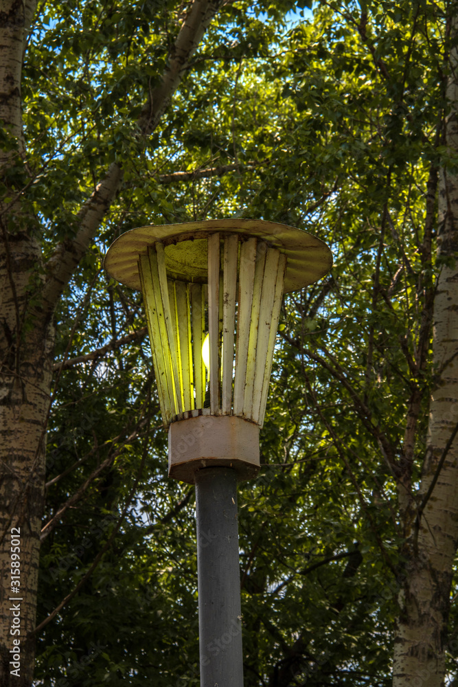 Old lantern among the leaves of the Park alley. The Damansky island, Yaroslavl