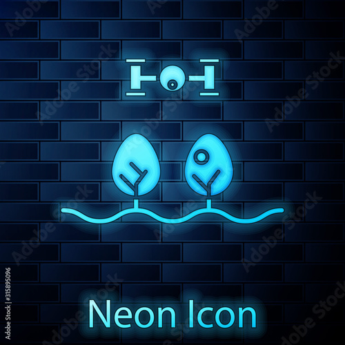 Glowing neon Smart farm with drone control and tree icon isolated on brick wall background. Innovation technology for agricultural company. Vector Illustration