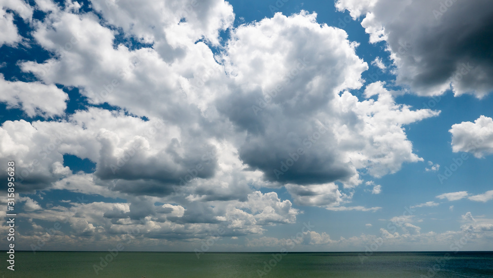 white dramatic clouds floating in the blue sky white dramatic clouds floating in the blue sky