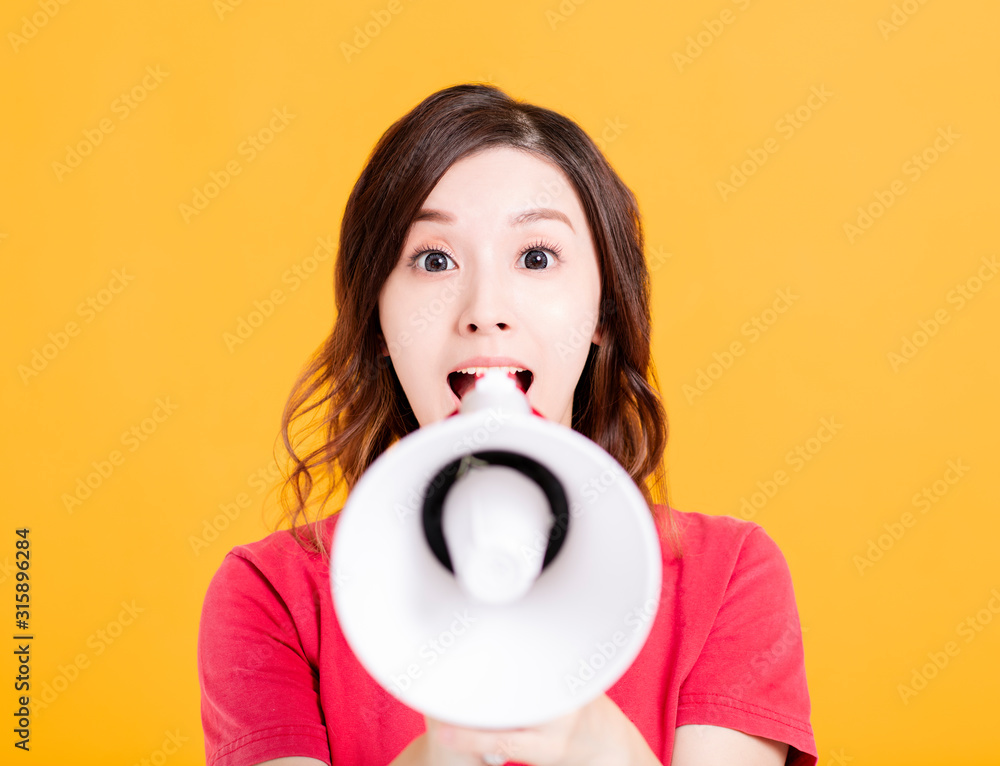 excited young woman with megaphone excited young woman with megaphone