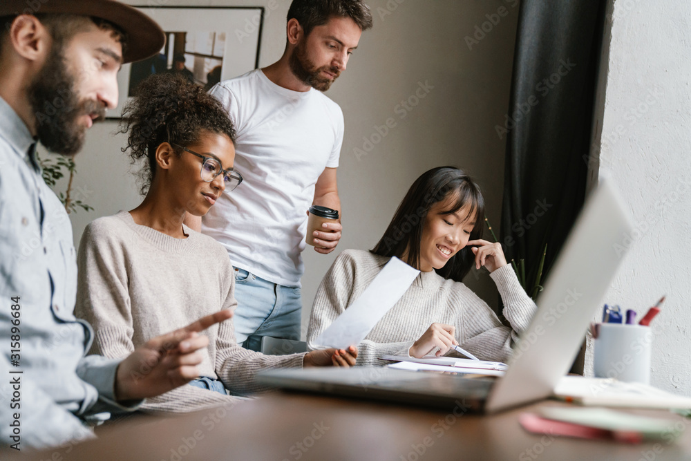 Obraz premium Image of multiethnic young business people working together at office