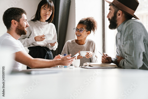Image of multiethnic young business people working together at office