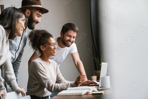 Image of multiethnic young business people working together at office