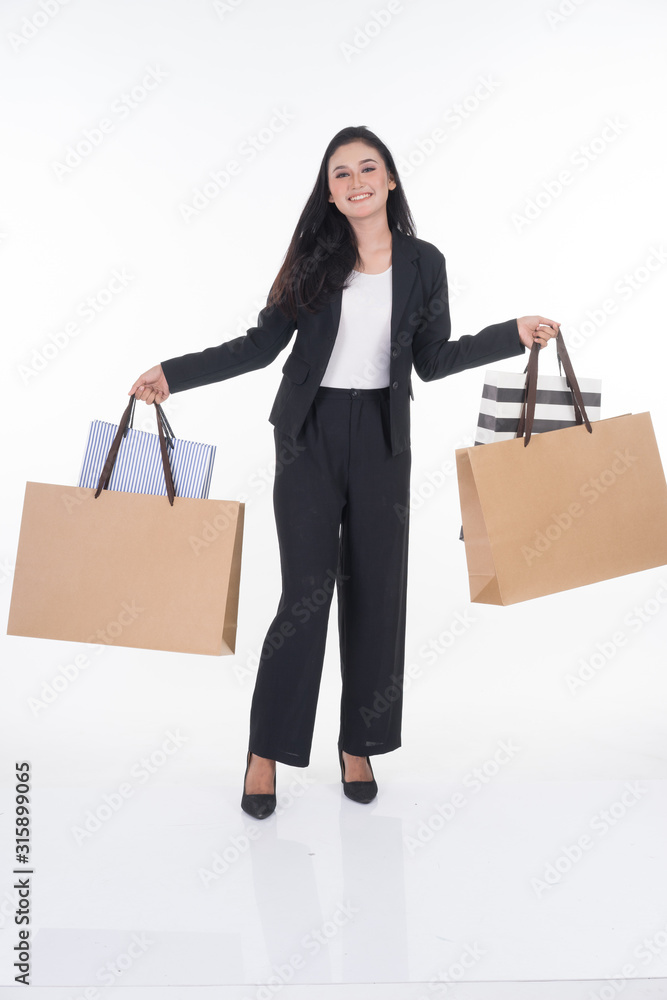 A beautiful Asian woman wearing officewear poses with shopping bags isolated on white background. Full body suitable for image cut out and manipulation works for business and commerce concepts. A beautiful Asian woman wearing officewear poses with shopping bags isolated on white background. Full body suitable for image cut out and manipulation works for business and commerce concepts.
