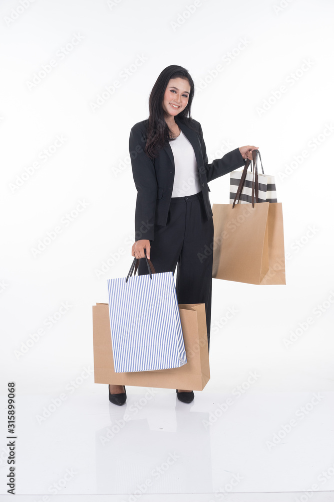 A beautiful Asian woman wearing officewear poses with shopping bags isolated on white background. Full body suitable for image cut out and manipulation works for business and commerce concepts. A beautiful Asian woman wearing officewear poses with shopping bags isolated on white background. Full body suitable for image cut out and manipulation works for business and commerce concepts.