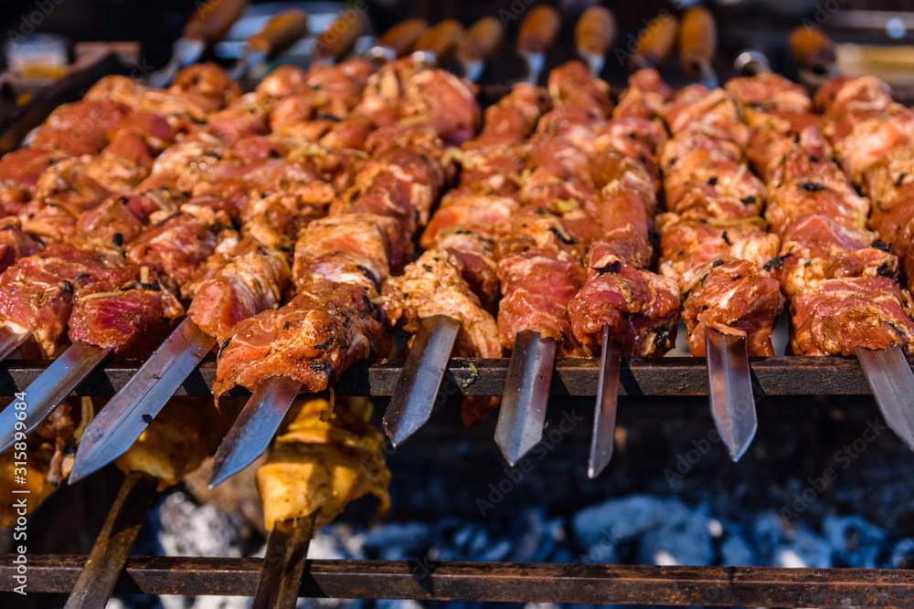 Skewers with meat over the charcoals. Cooking shashlik Skewers with meat over the charcoals. Cooking shashlik