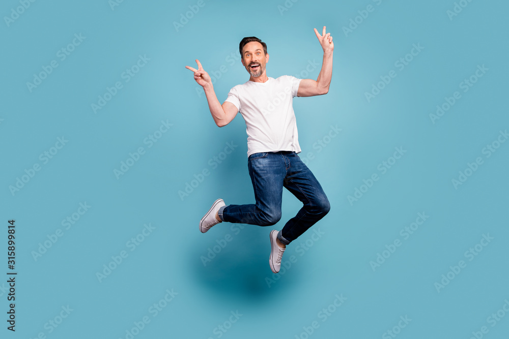 Full length body size view of nice attractive cheerful cheery funky comic guy jumping showing v-sign having fun isolated on bright vivid shine vibrant teal green blue turquoise color background