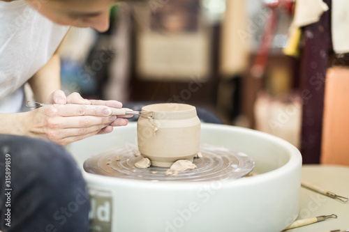 potter girl in the workshop with pottery