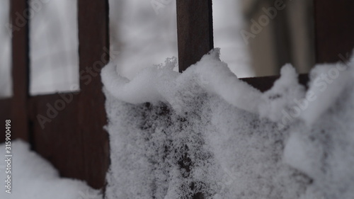 snow and ice on metal structures and tree branches