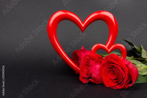 Valentine’s Day Background.Red Roses and Red Hearts. photo