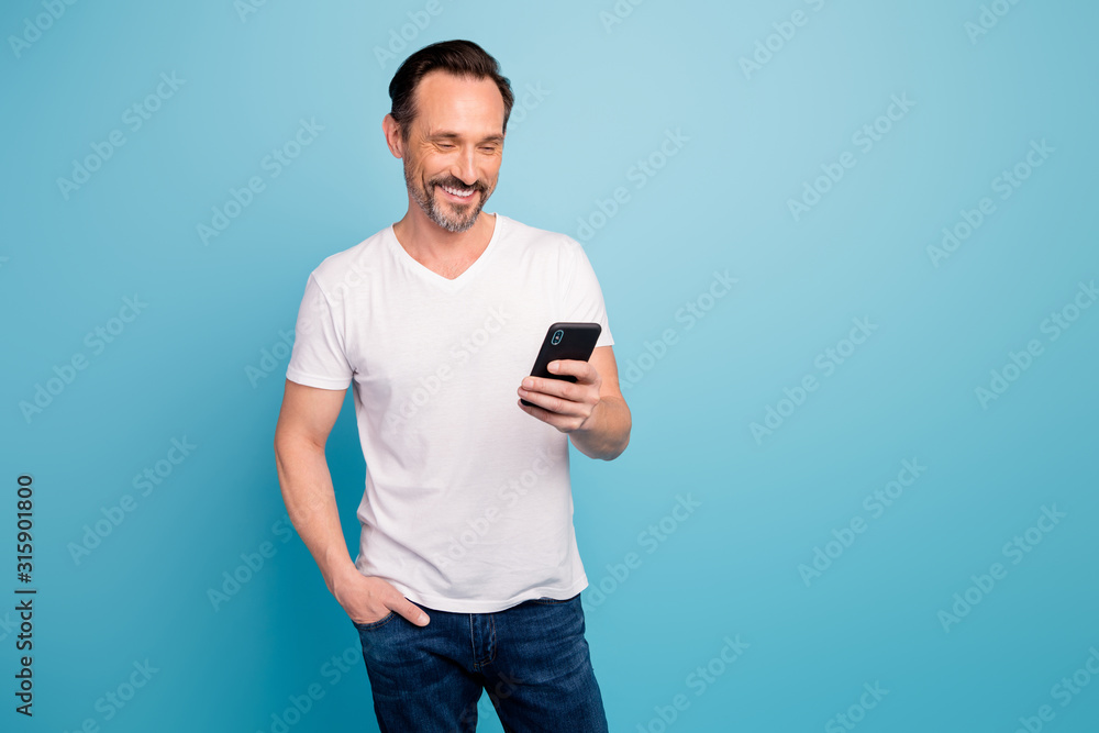 Portrait of his he nice attractive cheerful cheery content guy IT freelancer checking reading sms task salary isolated on bright vivid shine vibrant teal green blue turquoise color background Portrait of his he nice attractive cheerful cheery content guy IT freelancer checking reading sms task salary isolated on bright vivid shine vibrant teal green blue turquoise color background