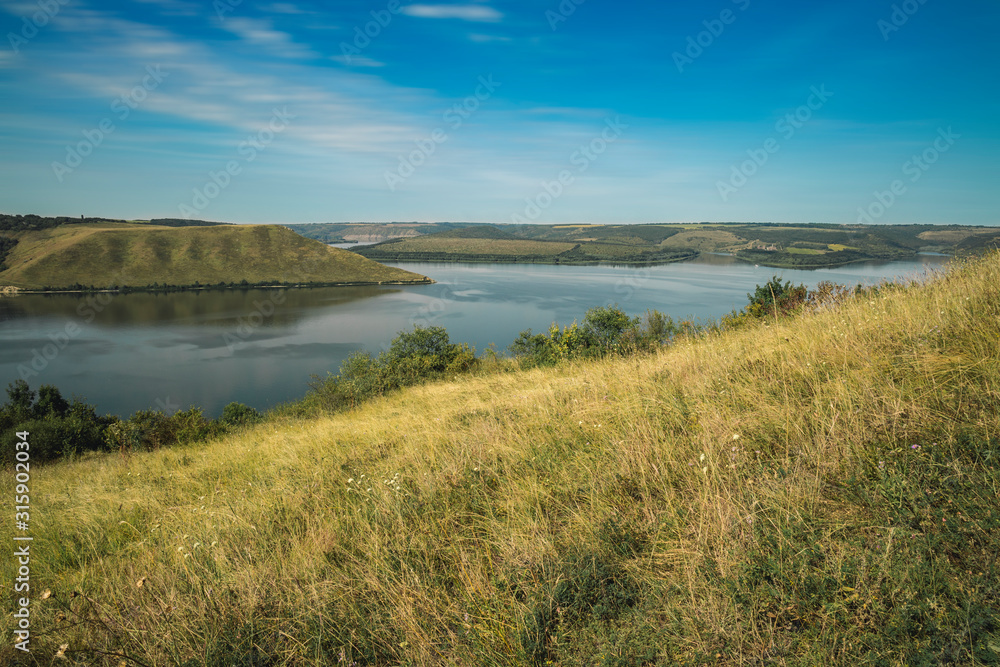 spring time landscape European nature reserve hill land peaceful lake water with horizon background scenic view clear weather day empty copy space for your text here