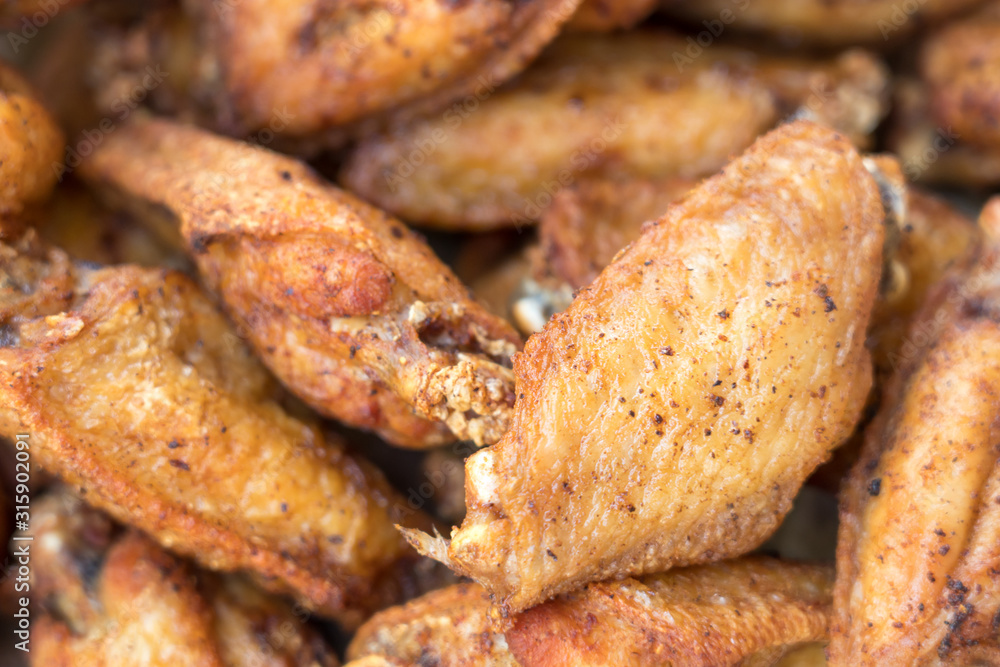 Close-up deep fried chicken wings with salt, Thai food. Close-up deep fried chicken wings with salt, Thai food.