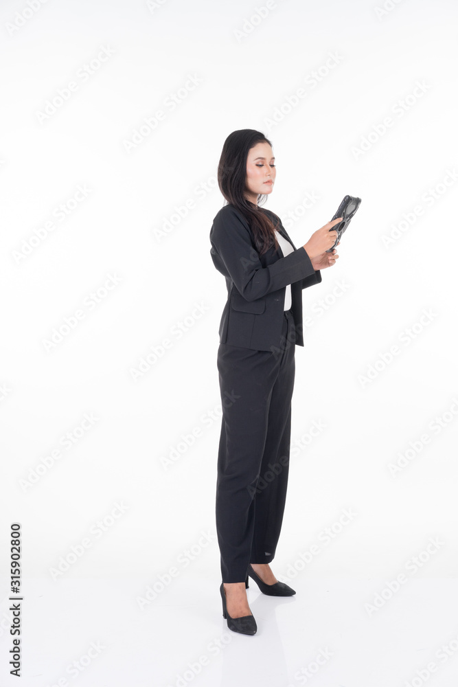 An attractive woman wearing business attire holding a tablet with various poses isolated on white background. Suitable for image cut out and manipulation works for technology,business or finance theme An attractive woman wearing business attire holding a tablet with various poses isolated on white background. Suitable for image cut out and manipulation works for technology,business or finance theme
