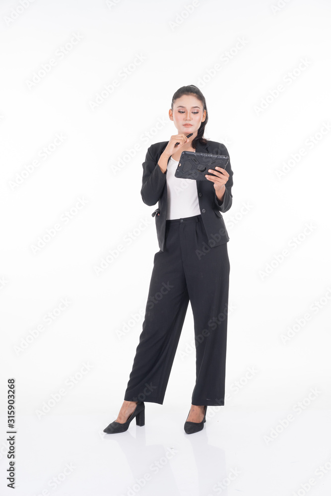 An attractive woman wearing business attire holding a tablet with various poses isolated on white background. Suitable for image cut out and manipulation works for technology,business or finance theme An attractive woman wearing business attire holding a tablet with various poses isolated on white background. Suitable for image cut out and manipulation works for technology,business or finance theme