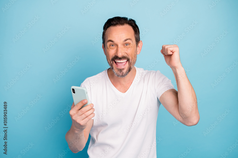 Close-up portrait of his he nice attractive cheerful cheery guy using app fast speed device celebrating comment like isolated on bright vivid shine vibrant teal green blue turquoise color background Close-up portrait of his he nice attractive cheerful cheery guy using app fast speed device celebrating comment like isolated on bright vivid shine vibrant teal green blue turquoise color background