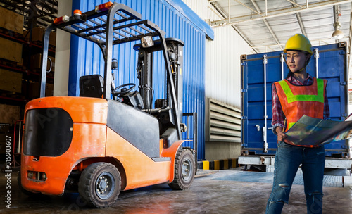 Forklift in warehouse with container
