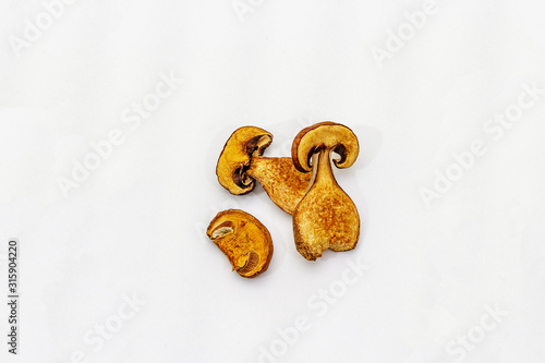 Dried porcini mushrooms isolated on white background. Traditional ingredient for cooking healthy food photo