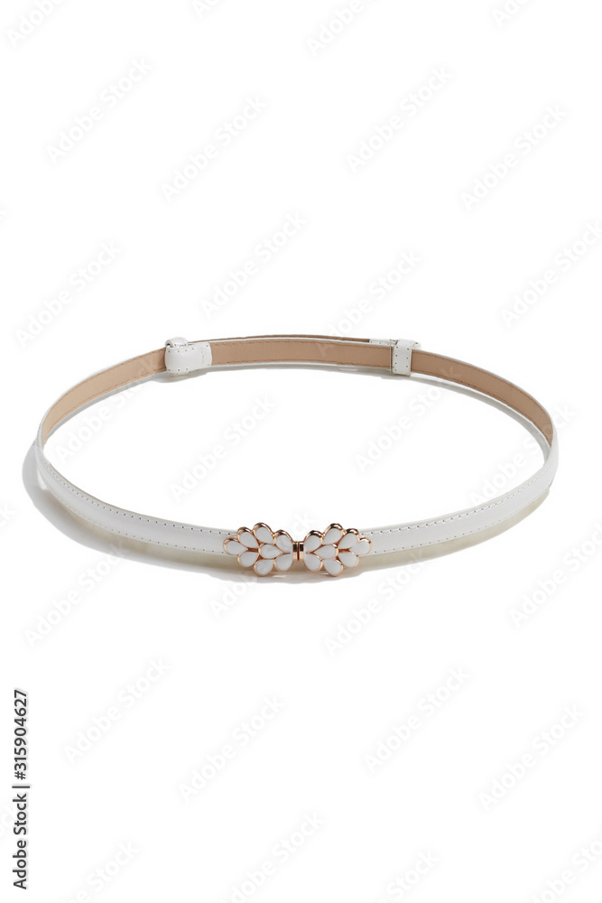 Subject shot of a thin belt made of white leather and decorated with a figured buckle in the form of golden drops with white jeweller's enamel. The stylish belt is isolated on the white background. Subject shot of a thin belt made of white leather and decorated with a figured buckle in the form of golden drops with white jeweller's enamel. The stylish belt is isolated on the white background.