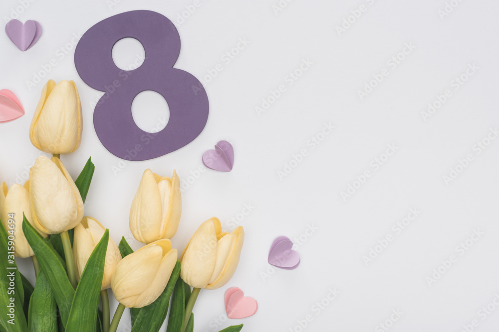 top view of tulips, paper hearts and number 8 isolated on white